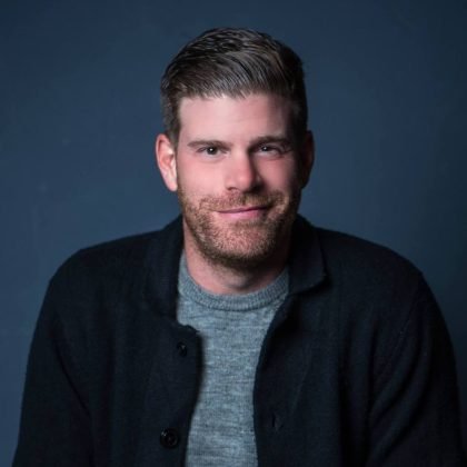Comedian Steve Rannazzisi smiling in a portrait promoting his New York City stand-up comedy shows.