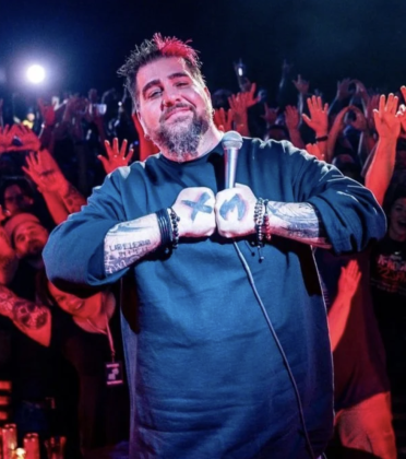 Comedian Big Jay Oakerson performing live on stage in New York City during a sold-out comedy show.