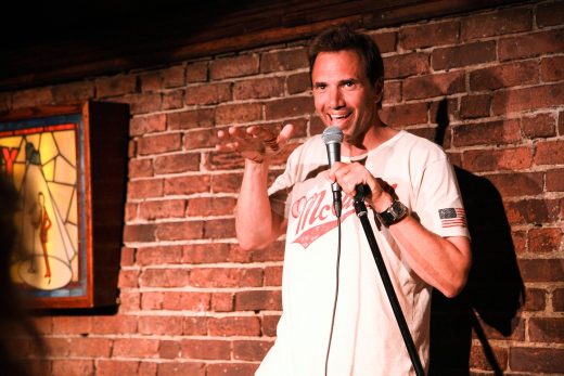 Paul Mecurio performing stand-up comedy at Comedy Cellar NYC on MacDougal Street.