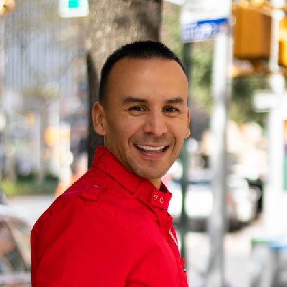 Pedro Gonzalez Colombian-American stand-up comedian smiling outdoors in New York City