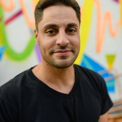 Dan Frigolette performing stand-up comedy on stage