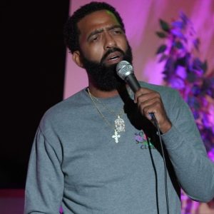 Nick Mitchell performing stand-up comedy on stage