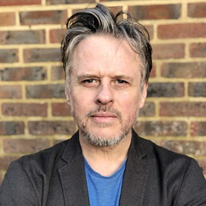 Robert Morgan performing stand-up comedy on stage​