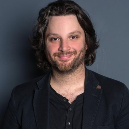 Avery Pearson performing musical comedy live on stage at a comedy club